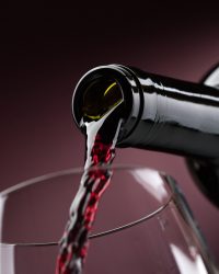 Pouring red wine into a wineglass